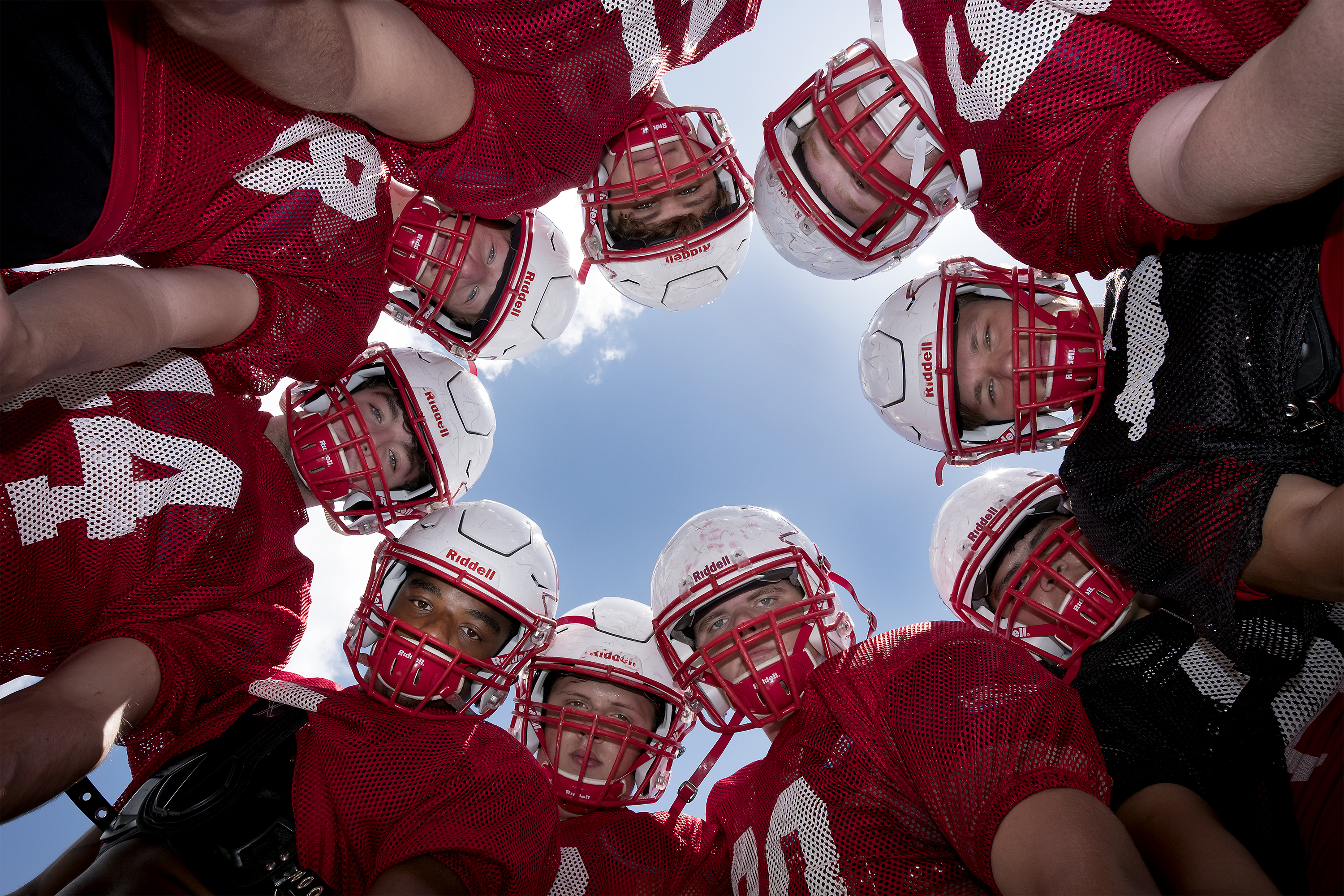 THS football looking up in the huddle